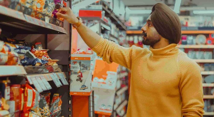 man choosing snacks at the supermarket